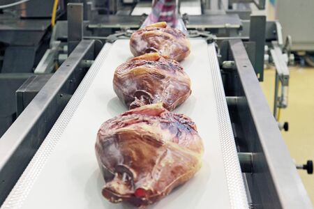 Line of packing of pieces of meat in a filmの写真素材