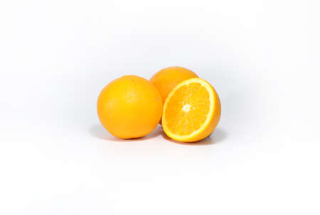 Half an orange in hand on a white background.の写真素材