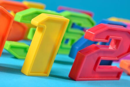 Colorful plastic numbers close up on a blue backgroundの写真素材