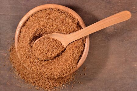 Brown sugar in a wooden bowlの写真素材