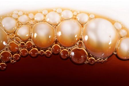 Bubbles of foam instant coffee on a whiteの写真素材