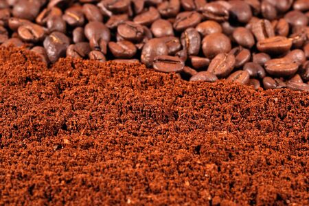 Heap of ground coffee and beans as backgroundの写真素材