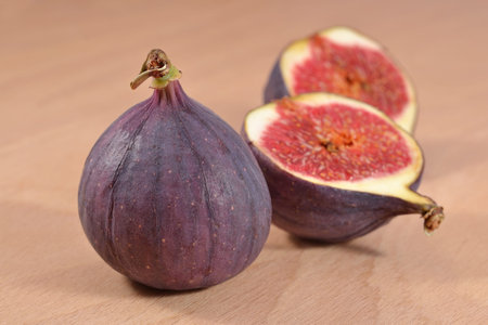Fresh figs halved on a wooden board