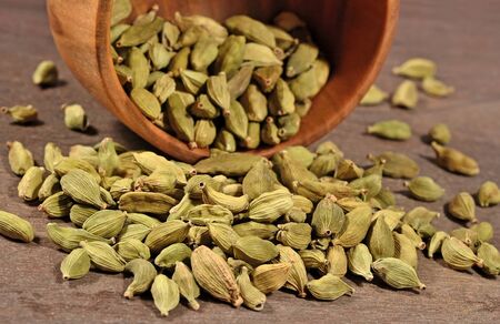 Cardamom seeds in a wooden bowlの写真素材
