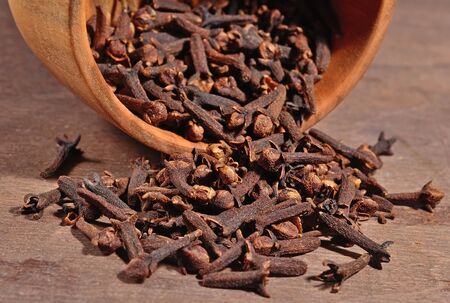 Dried clove in a wooden bowlの写真素材
