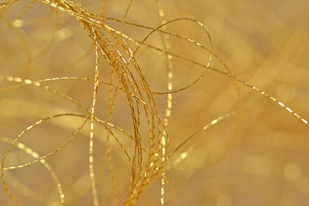 Golden threads close-us selective focus backgroundの写真素材