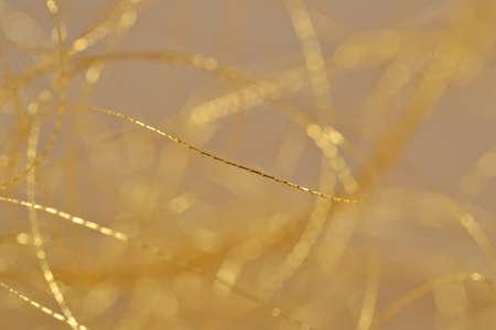 Golden threads close-us selective focus backgroundの写真素材
