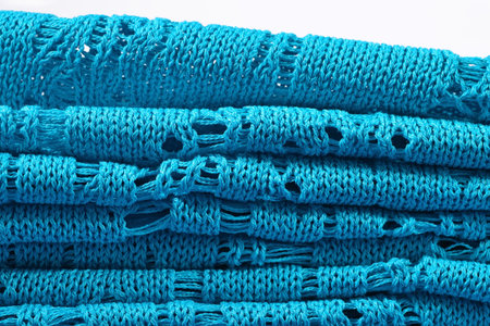 Stack of blue openwork knitted closeup