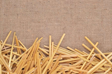 Straw on burlap as background textureの写真素材