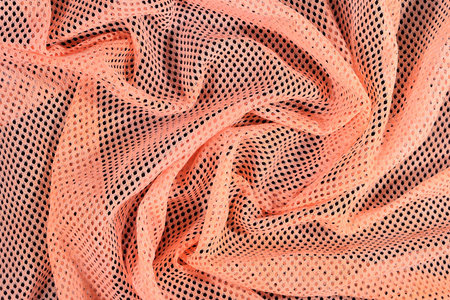 Orange crumpled nonwoven fabric as background texture