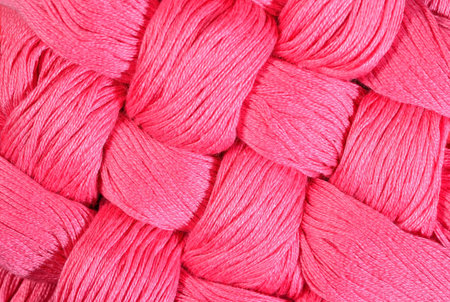 Pink twisted skeins of floss as background texture close up