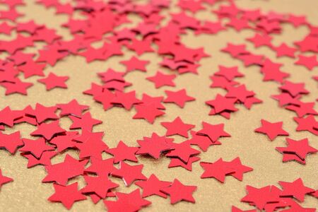 Confetti in the form of red stars as background textureの写真素材