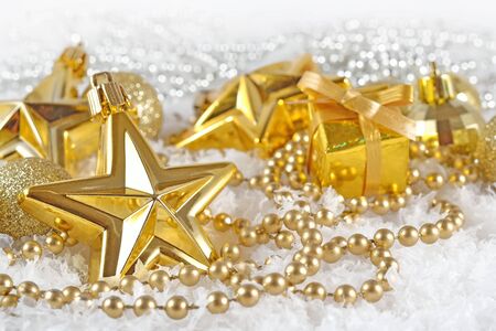 Golden  Christmas decorations on a white backgroundの写真素材