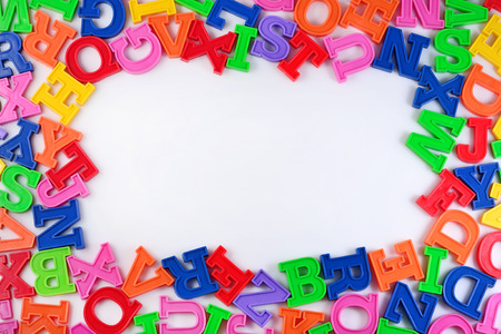 Frame of plastic colorful alphabet letters on a white backgroundの写真素材