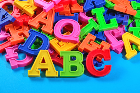 Plastic colored alphabet letters ABC on a blue backgroundの写真素材