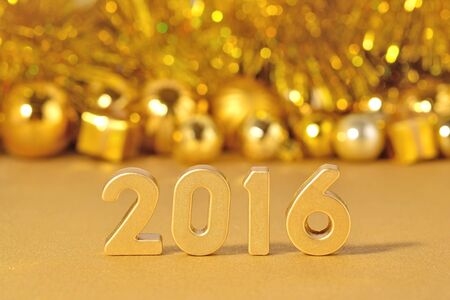 2016 year golden figures on the background of golden Christmas decorationsの写真素材