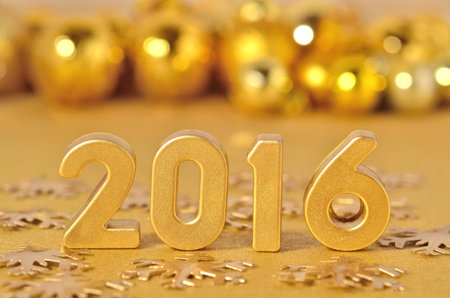 2016 year golden figures on the background of golden Christmas decorations