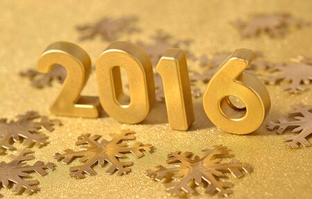 2016 year golden figures on the background of golden snowflakesの写真素材