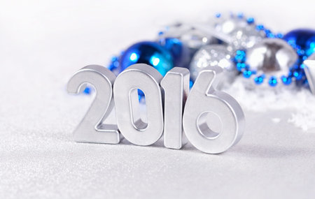 2016 year silver figures on the background of silvery and blue Christmas decorations