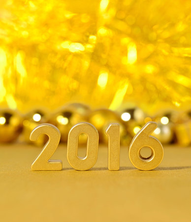 2016 year golden figures on the background of golden Christmas decorations
