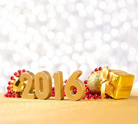 2016 year golden figures on the background of Christmas decorations