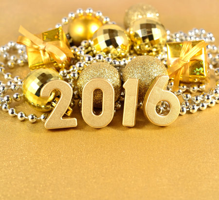 2016 year golden figures on the background of golden Christmas decorations
