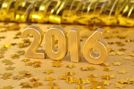 2016 year golden figures on the background of golden stars. Selective focus.の写真素材