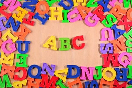 Plastic colored alphabet letters ABC on a wooden backgroundの写真素材