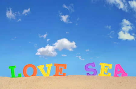 Love sea letters on a beach sand against the blue skyの写真素材
