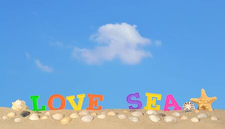 Love sea letters on a beach sand against the blue skyの写真素材