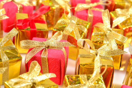Top view of golden and red gifts close-up as background