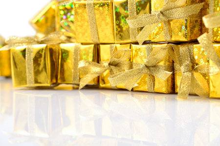 Golden gifts close-up on a white backgroundの写真素材