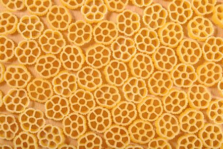 Uncooked italian pasta rotelle as background textureの写真素材