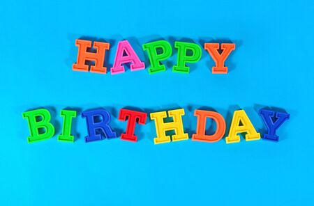 Happy birthday colorful text on a blue backgroundの写真素材