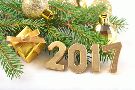2017 year golden figures and spruce branch and Christmas decorationsの写真素材