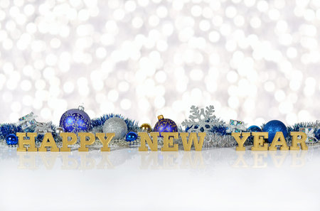 Happy New Year golden text on the background of Christmas decorations on a bokeh background