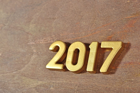 2017 year golden figures on a wooden background