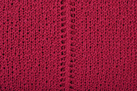Dark red openwork stockinet as background texture 