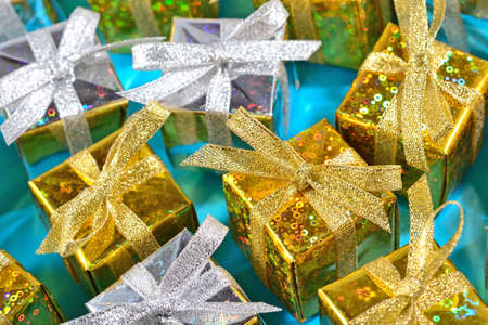 Top view of golden and silver gifts close-up on a blue background の写真素材