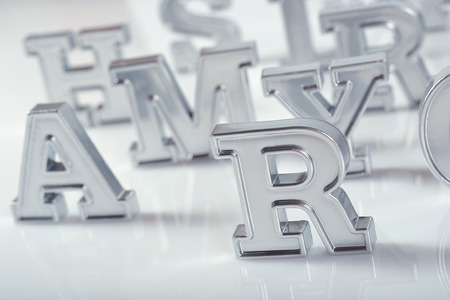 Silver alphabet letters close-up on a white backgroundの写真素材