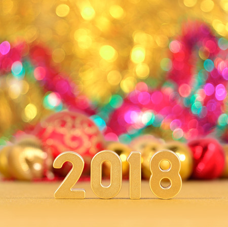 2018 year golden figures and Christmas decorations on a bokeh backgroundの写真素材