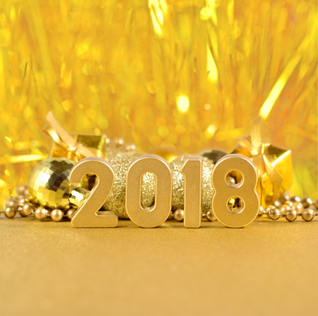 2018 year golden figures and Christmas decorations on a bokeh backgroundの写真素材