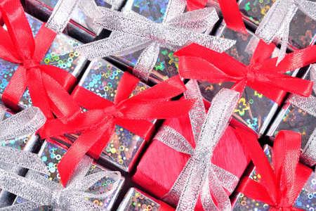 Top view of silver and red gifts close-up as background の写真素材