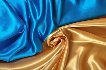 Natural golden and blue satin fabric as background textureの写真素材