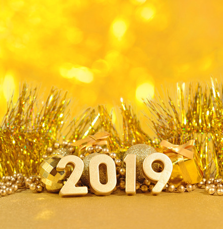 2019 year golden figures on the background of golden Christmas decorations on a bokeh backgroundの写真素材