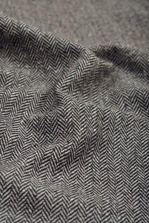 Draped herringbone tweed wool fabric as texture