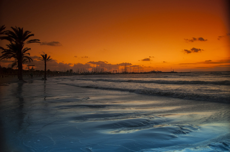 Sunset on the sandy beach on the island of Mallorcaの写真素材