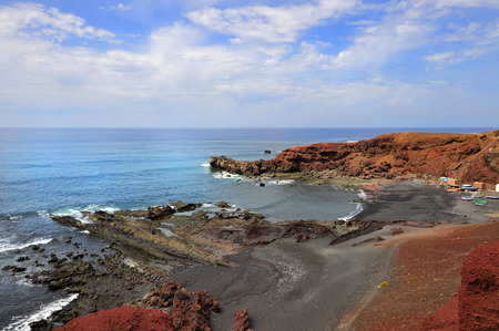 Scenic view on seashore with reef. Waves covered with foam.の写真素材