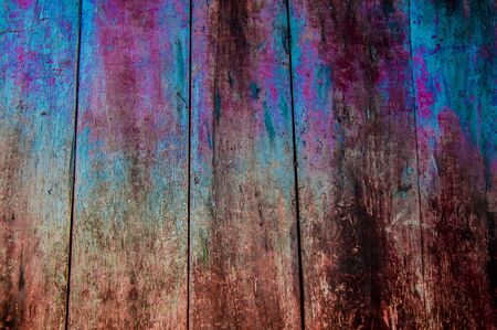 Close-up of grunge wooden wall painted in blue,pink and brown colorsの写真素材