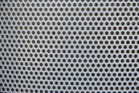 Close-up of perforated metal backdropの写真素材